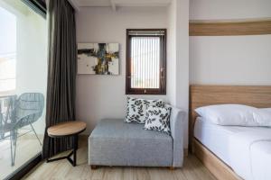 a bedroom with a bed and a chair and a table at Comfortable Villa in Quiet Area in Nusa Dua +44 photos