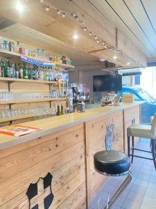 a bar in a restaurant with a black stool at Auberge le bois du cornet in La Forclaz