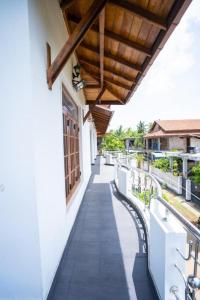 a balcony of a building with a wooden roof at Sky View Guest house in Batticaloa
