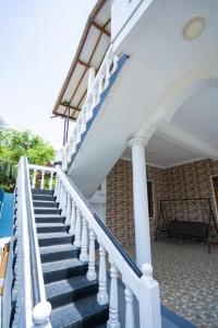 a staircase with blue and white railings on a house at Sky View Guest house in Batticaloa