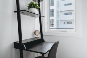 a desk and a chair in a room with a window at Downtown Traverse City Apartment near West Bay in Traverse City