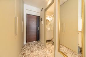 a hallway with a door and a mirror at Valentina Apartment in CityCenter in Budapest