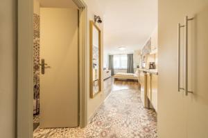 a hallway with a door leading to a kitchen and a bathroom at Valentina Apartment in CityCenter in Budapest