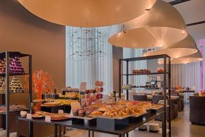 a bakery with a variety of pastries on display at Nhow Milan in Milan