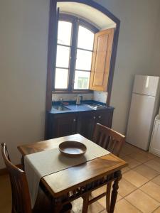 a kitchen with a wooden table and a sink at Casa Origenes in Haría +7 photos