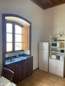 a kitchen with a sink and a refrigerator at Casa Origenes in Haría