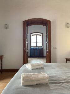 a bedroom with a bed with two towels on it at Casa Origenes in Haría