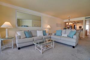 a living room with a couch and a table at Spectacular Sunsets at this Beachfront Condo in Bradenton Beach +21 photos