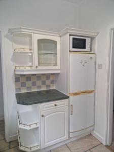 a kitchen with a white refrigerator and a microwave at Suite 2: Chic Room near City Centre in Sheffield
