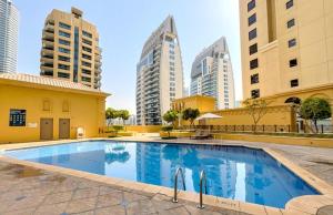 a swimming pool in a city with tall buildings at ROYAL BEACH RESIDENCES 2 in Dubai