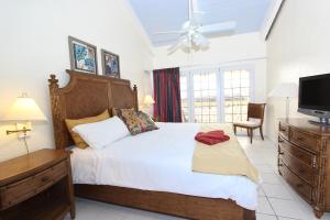 a bedroom with a large bed and a television at Ocean Reef Yacht Club & Resort in Freeport