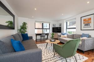 a living room with a couch and a table at Stay at Whitfield Street in London