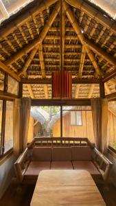 a large couch in a room with a large window at Zutalu - Playa Sur in Puerto López