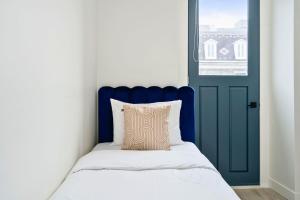 um quarto com uma porta azul e uma cama com uma almofada em Clouds Boutique Hotel em Montreal