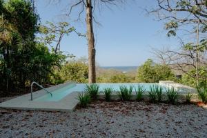 a swimming pool in the middle of a yard at Ocean view studio in Pelada! in Nosara