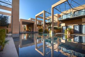 ein großes Gebäude mit einem Pool davor in der Unterkunft Luxueux Duplex 2CH dans une magnifique résidence in Marrakesch