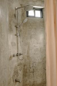 a shower in a bathroom with a window at Ocean view studio in Pelada! in Nosara