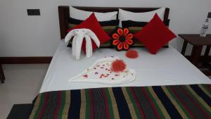 a bed with stuffed animals and decorations on it at Sigiri Jungle Villa in Sigiriya