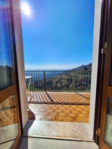 a door leading to a balcony with a view at La casa di Lilly in Volargne