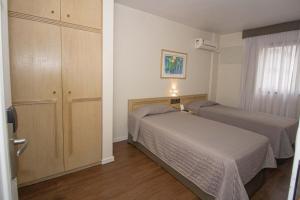 Postel nebo postele na pokoji v ubytování Trevi Hotel e Business