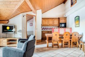 a kitchen and dining room with a table and chairs at Résidence La Ginabelle - maeva Home - Appartement 4 Pièces 8 Personnes - Sélection MAE-1965 in Chamonix-Mont-Blanc +22 photos