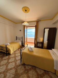 a bedroom with two beds and a view of the ocean at Villa Matilde Amalfi in Amalfi