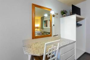 a bathroom with a counter with a mirror at Riverside Condo located Downtown Enjoy Nightlife in Bend