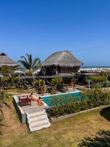 a resort with a swimming pool and a beach at Kite Eco House Salinas del rey in Salina de Rey
