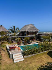 a resort with a swimming pool and a beach at Kite Eco House in Salina de Rey