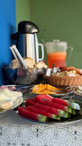 a table topped with plates of food on a table at Pousada Shalon Adonai Noronha in Fernando de Noronha