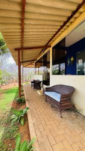 a patio with two benches on a house at Pousada Shalon Adonai Noronha in Fernando de Noronha