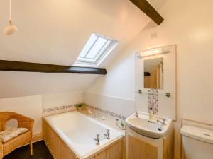 a bathroom with a bath tub and a sink at 4 Bed in Keswick 86392 in Rosthwaite