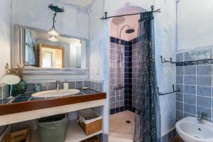 a bathroom with a sink and a mirror at B&B Calata Di Soli in Miniera dellʼArgentiera +42 photos