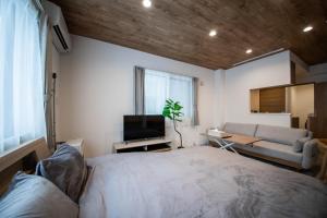 a bedroom with a large bed and a couch at 101 - Vacation STAY 16274 in Asahikawa