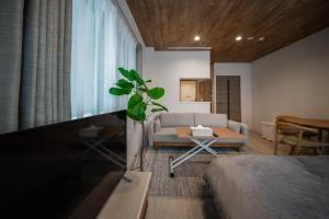 a living room with a couch and a table at 101 - Vacation STAY 16274 in Asahikawa