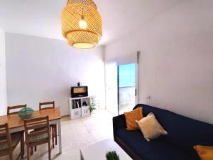 salon z niebieską kanapą i stołem w obiekcie Seaview Apartament, Playa Chica, Las Gaviotas, Apartamento 311 w mieście Santa Cruz de Tenerife