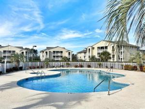 a swimming pool in front of some apartment complexes at Watch the Yachts Waterway Landing Retreat w Pool in Myrtle Beach