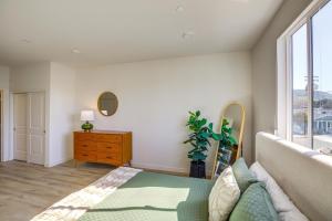 a bedroom with a couch and a dresser and a window at Chic San Luis Obispo Condo Near Hiking and Beaches! in San Luis Obispo