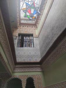 a room with a ceiling with a stained glass window at Dar Amane - Charmante maison marocaine in Marrakech