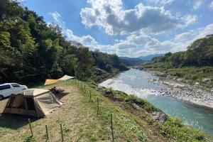 a tent on the side of a river at Nagatoro Camp Village - Vacation STAY 06872v in Minano