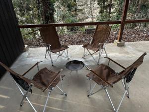 three chairs and a fire place on a porch at Nagatoro Camp Village - Vacation STAY 06871v in Minano
