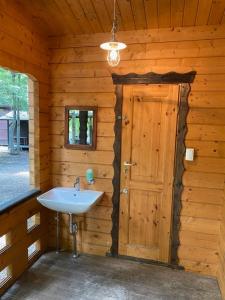 a bathroom in a log cabin with a sink at Nagatoro Camp Village - Vacation STAY 06873v in Minano