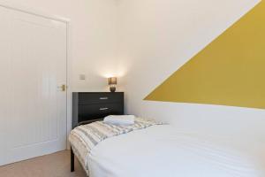 a small bedroom with a bed and a dresser at Elton House - Prime Location - Free Parking, Fast WiFi and Smart TV by Yoko Property in Redcar +20 photos
