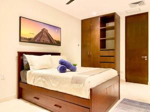a bedroom with a purple stuffed animal sitting on a bed at Marila by Andiani Travel in Playa del Carmen