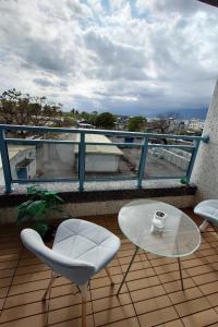 a balcony with a table and chairs on a building at 賞星月沐文創館Enjoy Star丨網紅民宿丨親子友善丨寵物友善丨療癒民宿丨包棟自動麻將機卡拉OK機丨雅致庭院丨近機場娜路彎酒店 l 可自助入住 l 戶外野餐 in Taitung City