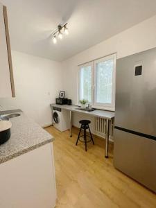 a kitchen with a refrigerator and a table in it at Útulný byt blízko centra Košíc in Košice