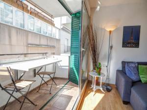 a living room with a table and a couch at Carmen Apartment by Hello Homes Sitges in Sitges