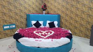 a bed with a heart made out of flowers at Hotel Bhavya Palace in Anand