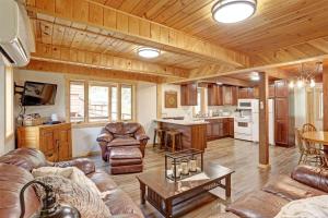 a living room with leather furniture and a kitchen at Trail Mountain Cabin in Lead +25 photos