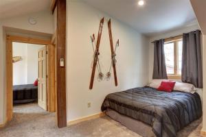 a bedroom with skis hanging on the wall at Trail Mountain Cabin in Lead